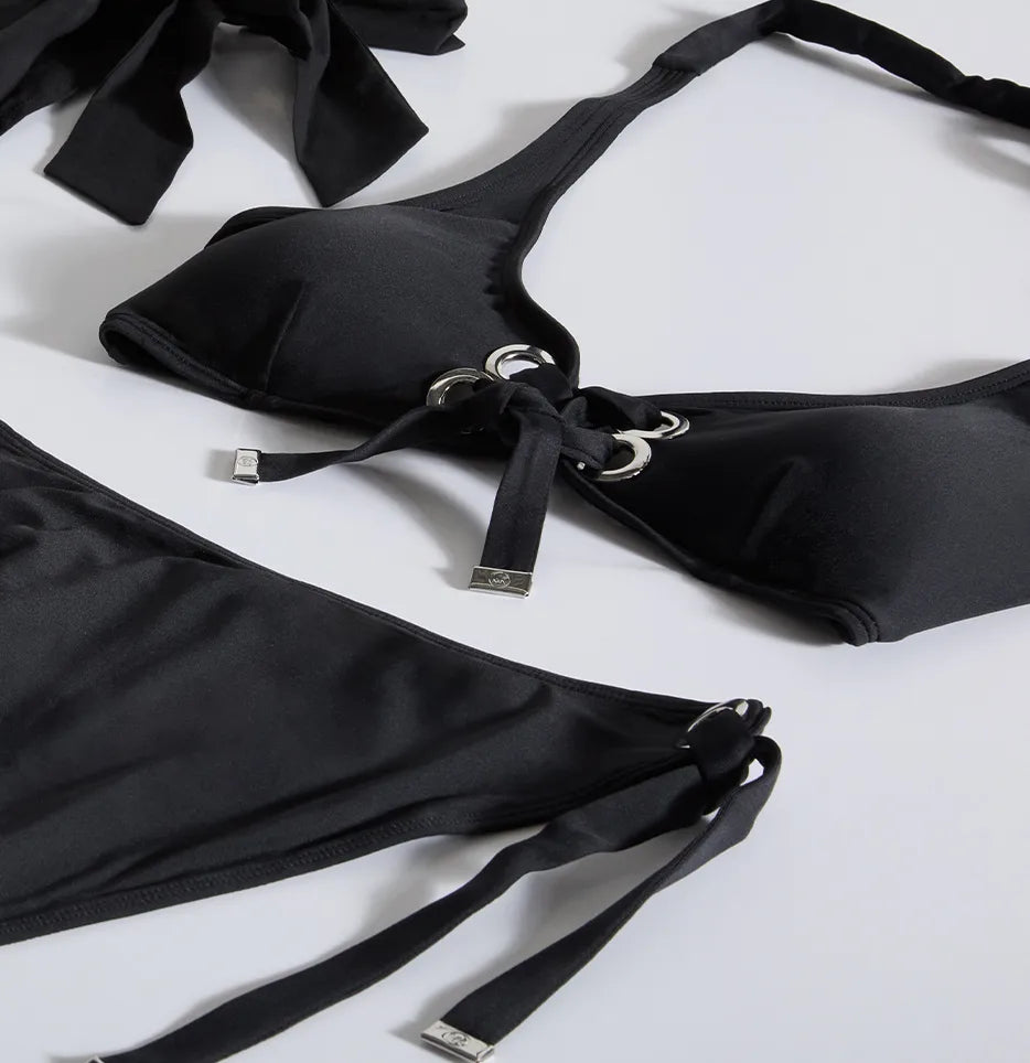 Hardware - laydown of black bikini set with hardware grommet details
