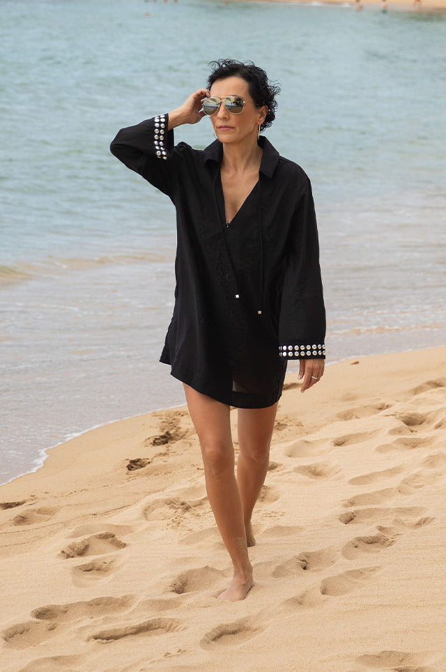 @stylewitheugenia: a woman wearing a black cover up on the beach